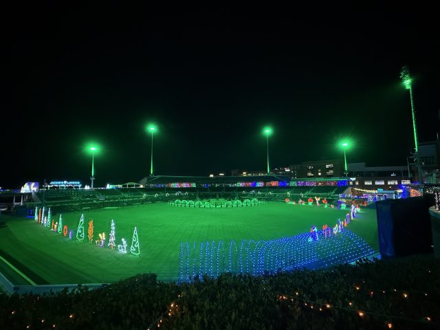 Durham Bulls Stadium with green stadium lights and holiday lights inside